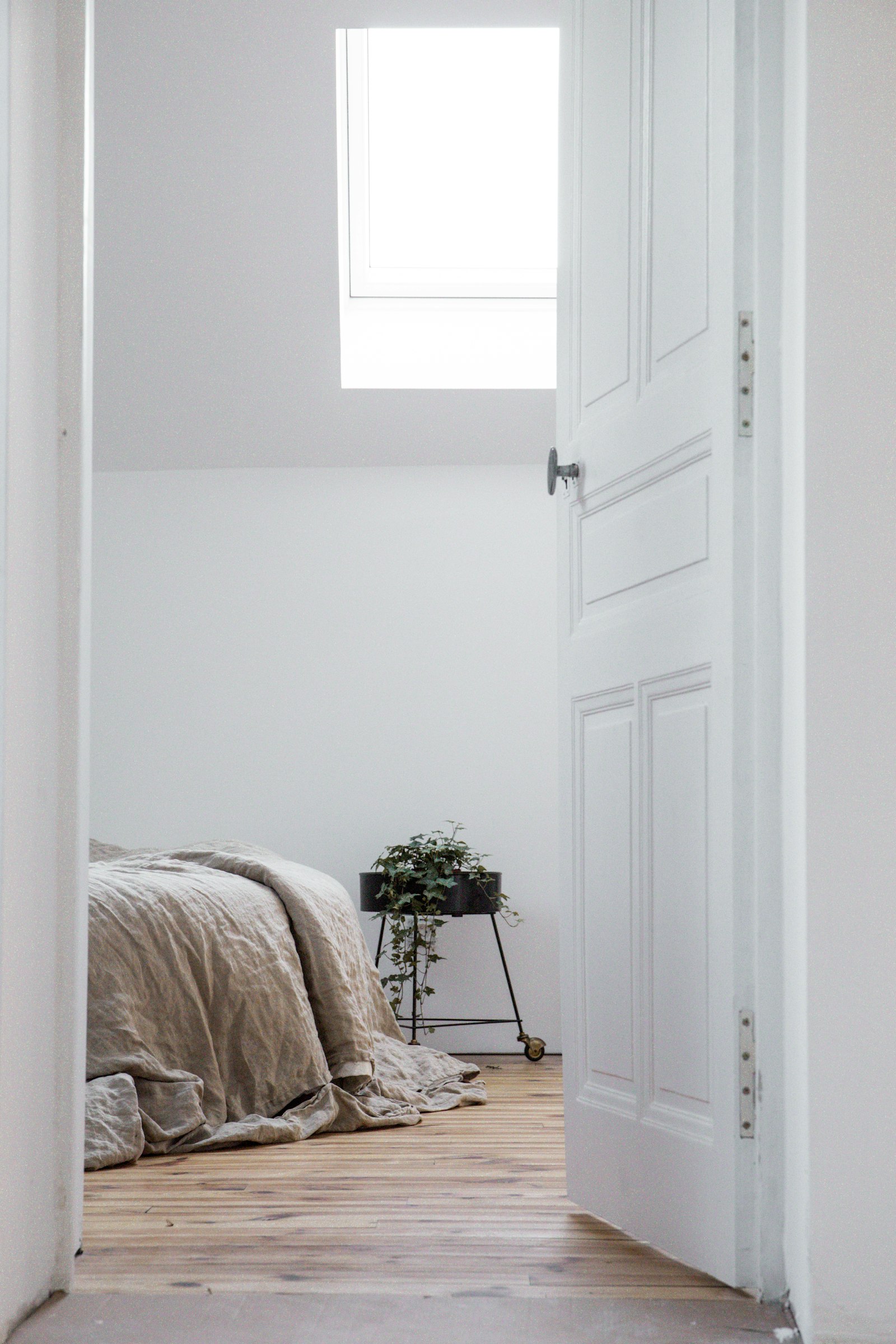 Bedroom with linen bedding and skylight
