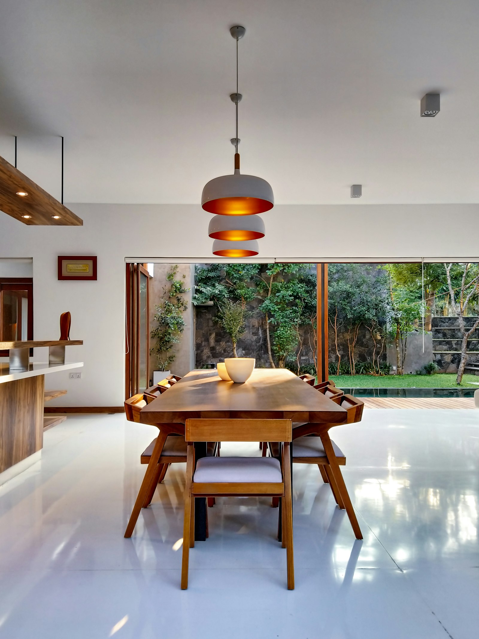 Dining table with pendants overlooking garden