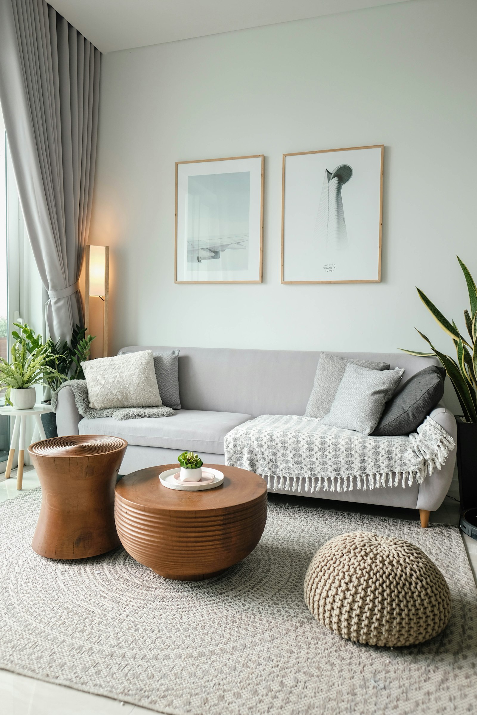 Loft living room with framed prints and gray sofa